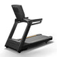 Matrix Endurance black treadmill with padded seat back, gray running belt, and gold accent stripe on white background