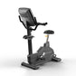 Matrix Endurance upright stationary exercise bike with black frame, digital console, handlebars, and padded seat on white bac