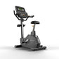 Matrix Endurance upright exercise bike with black frame, digital display console, and black seat on white background