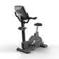 Matrix Endurance upright stationary exercise bike with black frame, digital console, handlebars, and padded seat on white bac