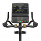 Matrix Endurance upright exercise bike with black frame, curved handlebars with yellow accent controls, and digital console d