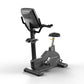 Matrix Endurance black upright exercise bike with digital display, handlebars, and padded seat on white background