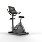 Matrix Endurance upright exercise bike with black frame, digital display console, handlebars, and black padded seat on white 