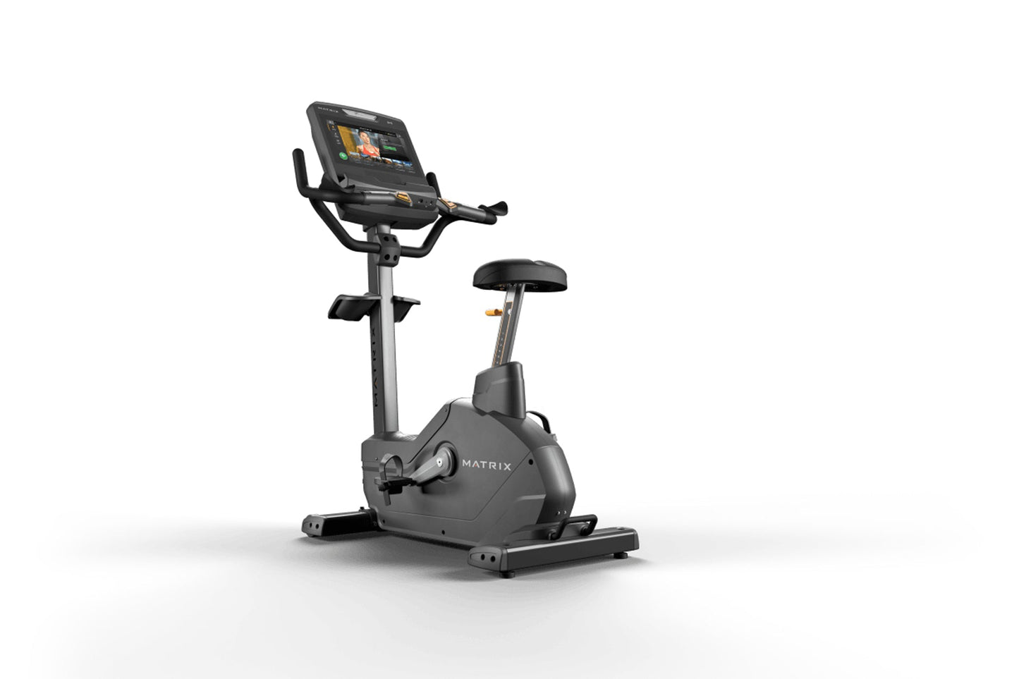 Matrix Endurance upright exercise bike with black frame, digital display console, handlebars, and black padded seat on white 