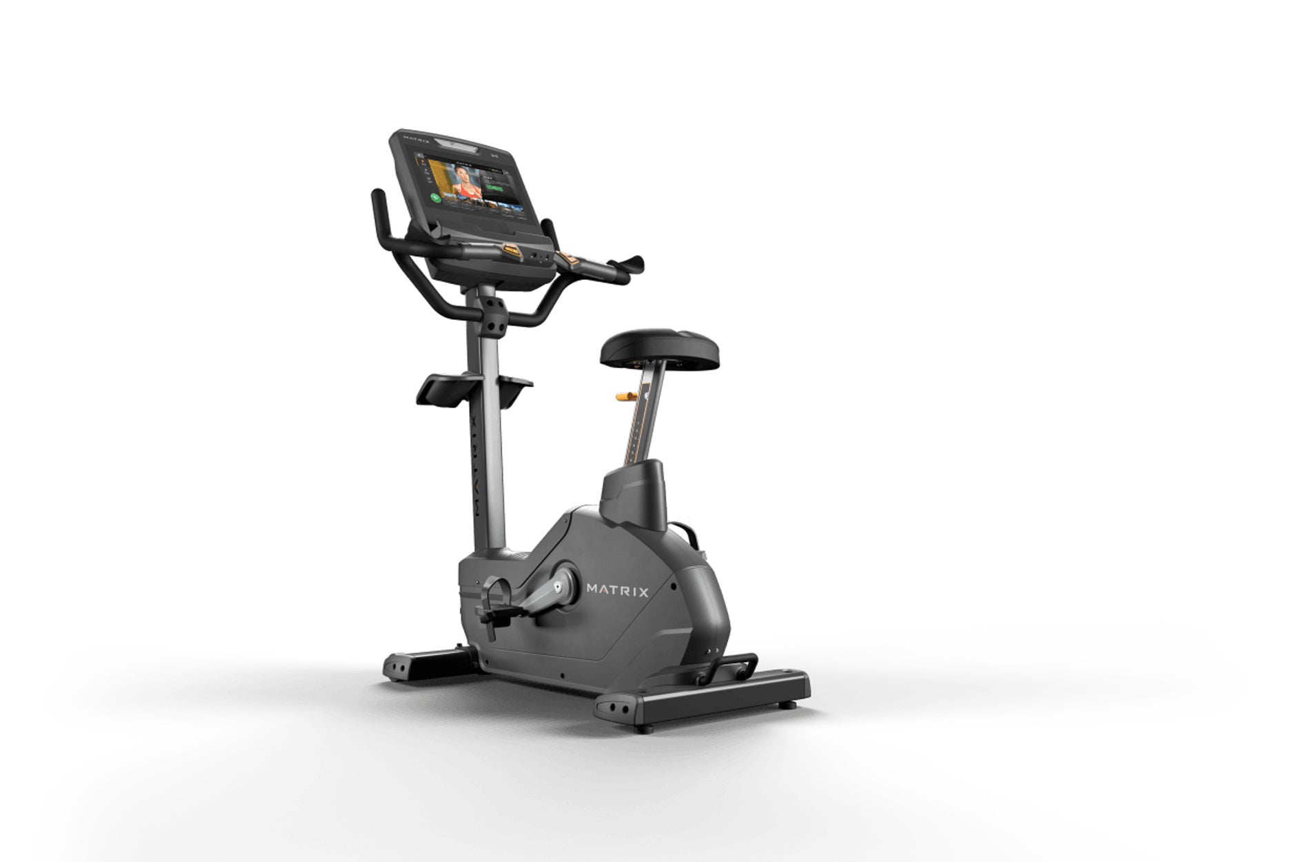 Matrix Endurance upright exercise bike with black frame, digital display console, handlebars, and black padded seat on white 