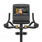 Matrix Endurance upright exercise bike with black frame, curved handlebars with yellow accent buttons, and touchscreen consol