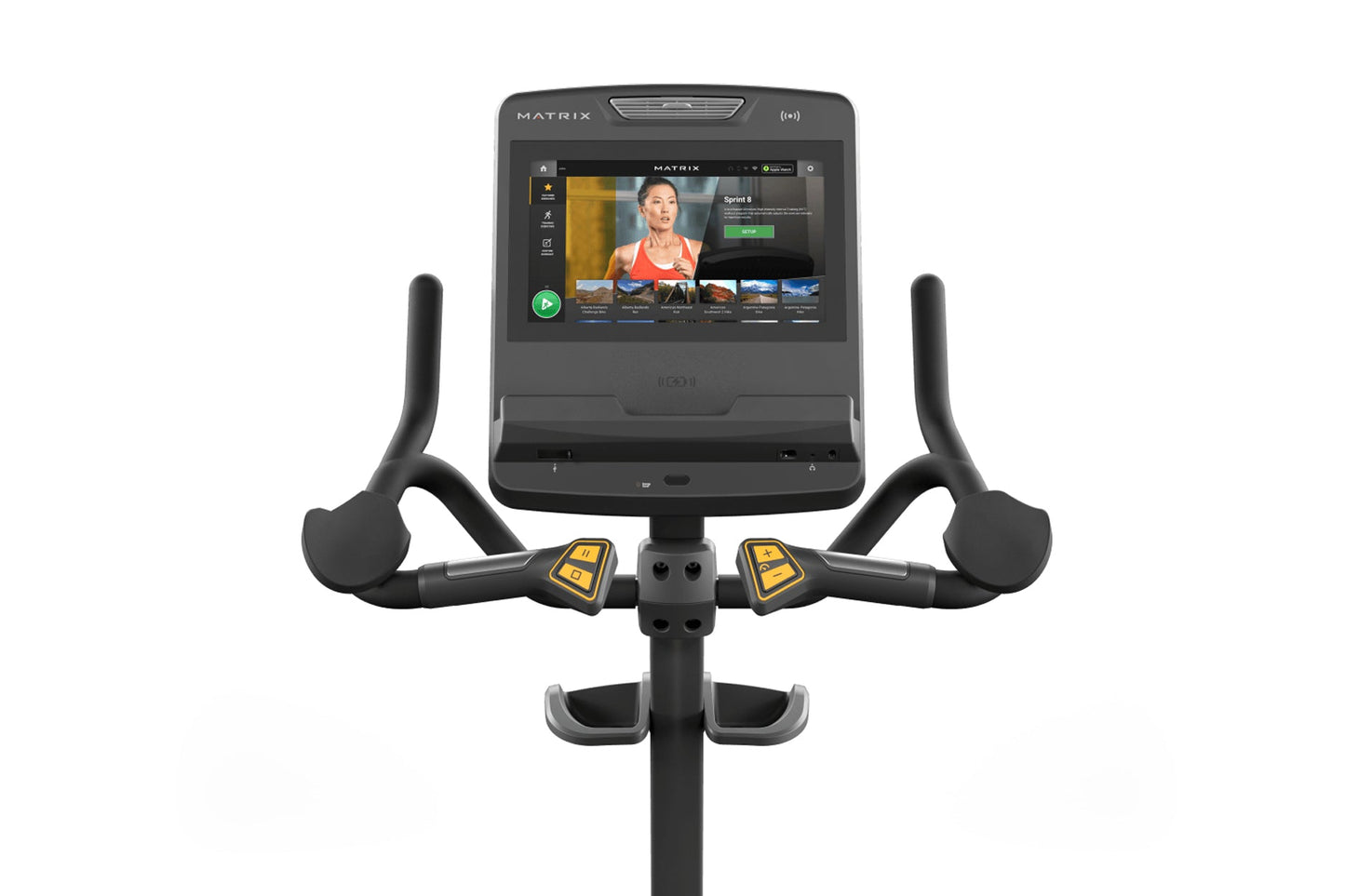 Matrix Endurance upright exercise bike with black frame, curved handlebars with yellow accent buttons, and touchscreen consol