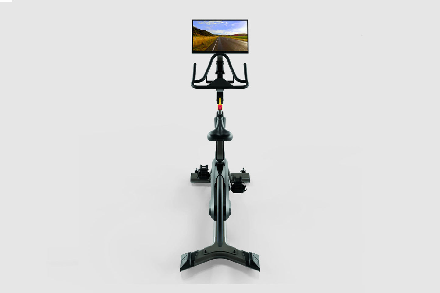 Black stationary indoor exercise bike with tablet mount displaying road landscape, viewed from front on white background