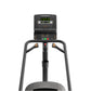 Matrix Lifestyle ClimbMill with black frame, dual handles, digital console displaying green readout, and gray base on white b