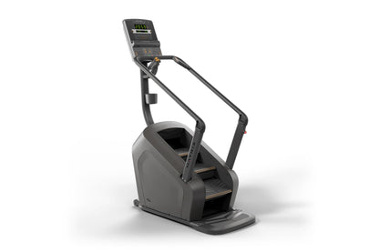 Black stair climbing exercise machine with digital display console showing calorie count and bronze accents on steps, on whit
