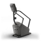 Matrix Lifestyle ClimbMill stair climbing exercise machine with dark gray frame, digital display console, and handrails on wh