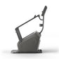 Charcoal gray stationary climbing machine with adjustable handlebars and digital display, on white background