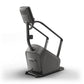 Matrix Lifestyle ClimbMill stair climber machine in charcoal gray with black frame and digital console display, isolated on w