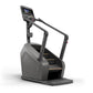 Matrix Lifestyle ClimbMill with gray and black frame, digital display console, dual handrails, and textured step platform on 