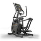 Black and gray elliptical machine with digital display console, handlebar arms, and footrests on white background
