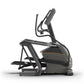Black and gray Matrix elliptical machine with adjustable handlebars and footrests on white background