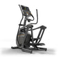 Black and gray elliptical machine with digital console display, handlebar grips, and foot pedals on white background