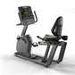 Matrix Lifestyle recumbent exercise bike with gray frame, black seat, digital touchscreen console, and foot pedals on white b