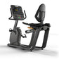 Matrix Lifestyle black recumbent exercise bike with digital display console, backrest, and foot pedals on white background