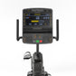 Matrix Lifestyle Recumbent Cycle with digital display showing sprint metrics, black frame with dual handles, on white backgro