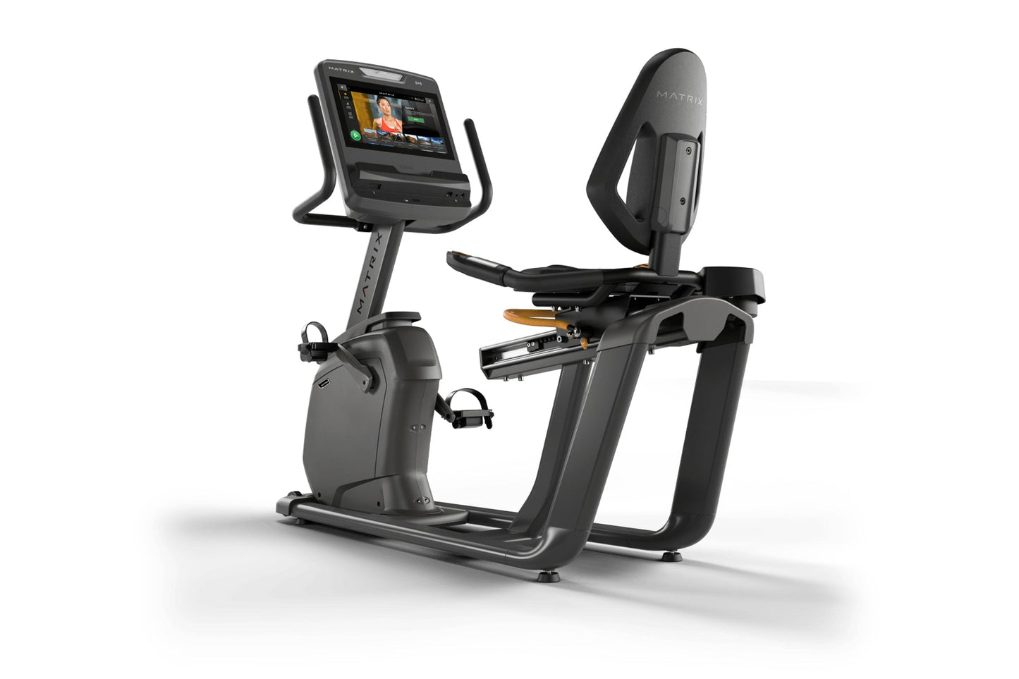 Matrix Lifestyle recumbent exercise bike with black frame, digital display console, and padded backrest on white background