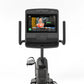 Matrix Lifestyle Recumbent Cycle with black frame, large touchscreen console displaying fitness app, and dual handlebar grips