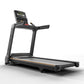 Black motorized treadmill with digital display console, orange accent stripe, and handrails on white background