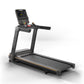 Black and gray motorized treadmill with digital console display, orange accent trim, and handrails, on white background