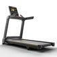 Black Matrix treadmill with integrated touchscreen display, orange accent stripe, and cushioned running deck on white backgro
