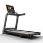 Black Matrix treadmill with orange accent stripe, digital touchscreen display mounted on angled console, handrails on sides, 