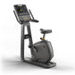 Matrix Lifestyle upright exercise bike with digital console display, black frame, padded seat, and handlebar grips on white b