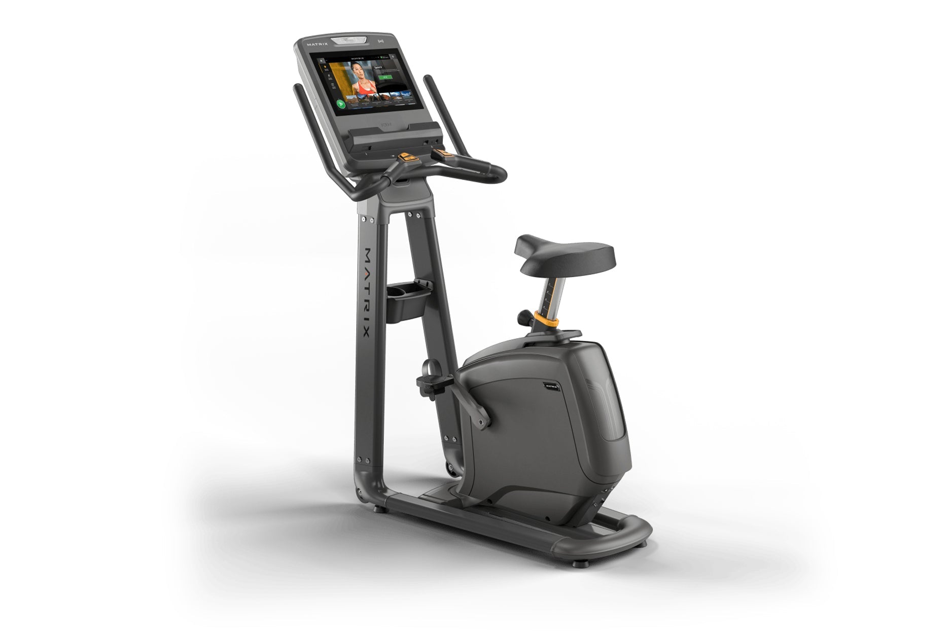 Matrix black upright exercise bike with touchscreen display, handlebar grips, pedals, and cushioned seat on white background