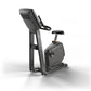 Matrix dark gray upright stationary bike with digital display console and black padded seat on white background