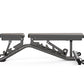 Matrix multi-adjustable weight bench with gray frame, padded seat and backrest, adjustable leg extension, on white background