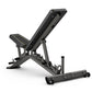 Matrix multi-adjustable weight bench with black padding and gray frame, incline backrest, and leg extension attachment on whi