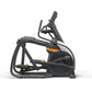 Black and gray elliptical trainer with orange accents, adjustable handles, and large pedal footplate on white background