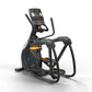 Black and orange elliptical trainer with digital console displaying time and metrics, featuring curved handles and foot pedal