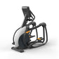 Matrix Performance Ascent Elliptical Trainer with white and black frame, dark display console, orange accents, and foot pedal
