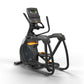 Black and orange elliptical trainer with digital console display, foot pedals, and handlebar grips on white background