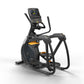 Black and orange elliptical trainer with digital console display, dual handles, and foot pedals on white background