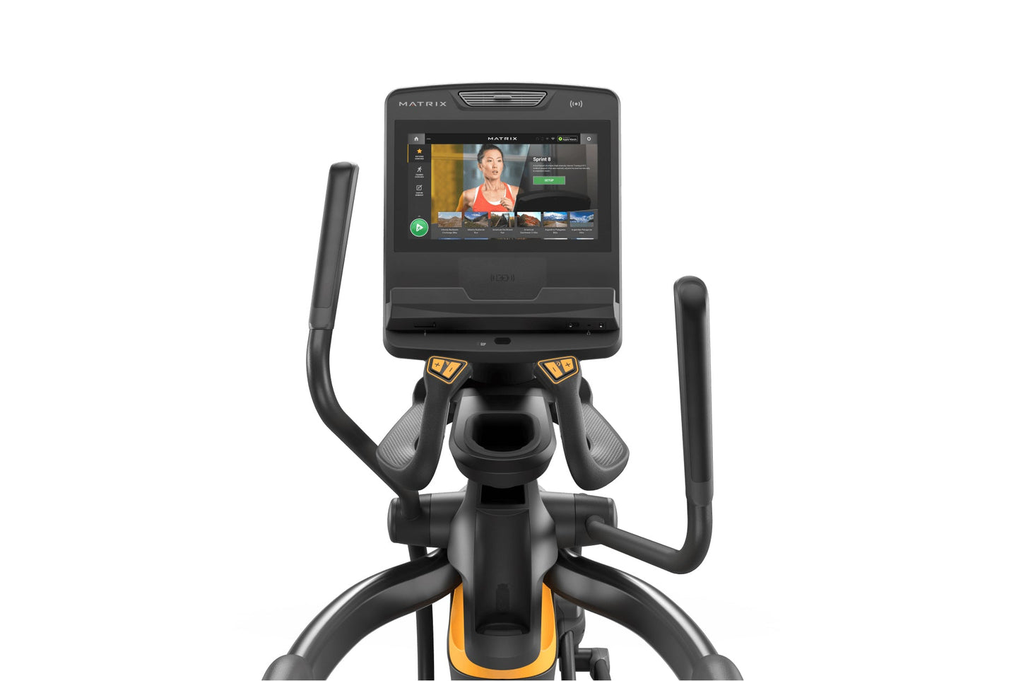 Black and gold Matrix elliptical trainer with dual handles, foot pedals, and touchscreen display showing workout interface on