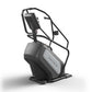 Matrix Performance ClimbMill with black and gray frame, digital console, and climbing step platform on white background