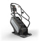 Matrix Performance ClimbMill with black frame, gray panel, digital console displaying metrics, and handrails on white backgro