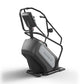 Matrix Performance ClimbMill with black frame, gray console, and handlebar display on white background