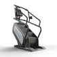 Matrix Performance ClimbMill with black frame, gray console with digital display, and dual handrails on white background