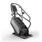 Matrix Performance ClimbMill with black frame, gray panel, digital display console, and dual handles on white background