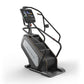 Matrix Performance ClimbMill with black frame, white side panel, digital touchscreen display, and dual handrails on white bac