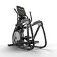 Black and gray elliptical machine with digital display console and suspension pedals on white background