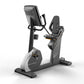 Matrix Performance Hybrid Cycle upright exercise bike with black seat, digital console, and gray base on white background