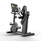 Matrix Performance Hybrid Cycle stationary exercise bike with digital console, black frame, padded seat, and pedal straps on 
